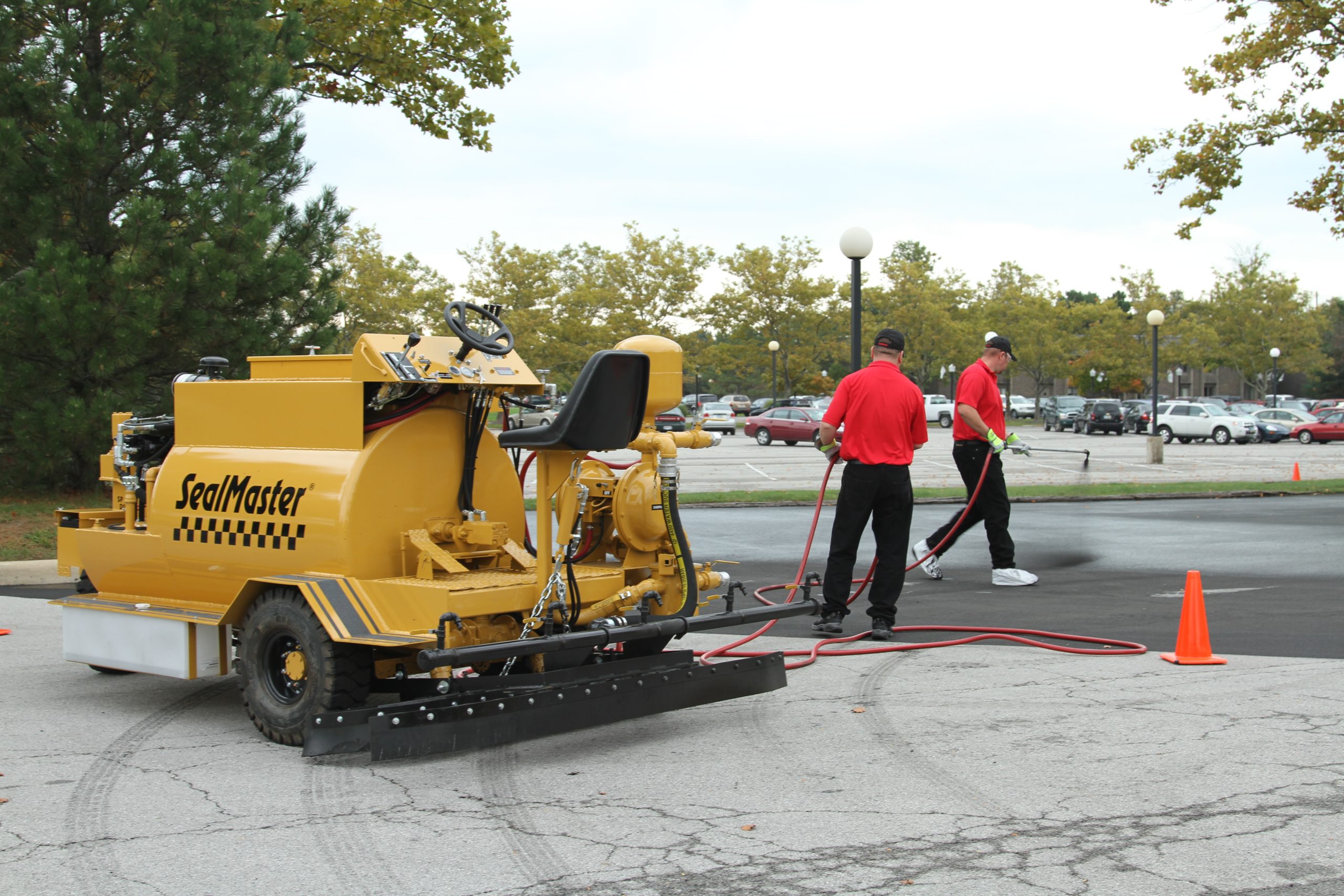 Sealcoating contractors using SealMaster equipment to sealcoat a parking lot in Sandusky, OH.