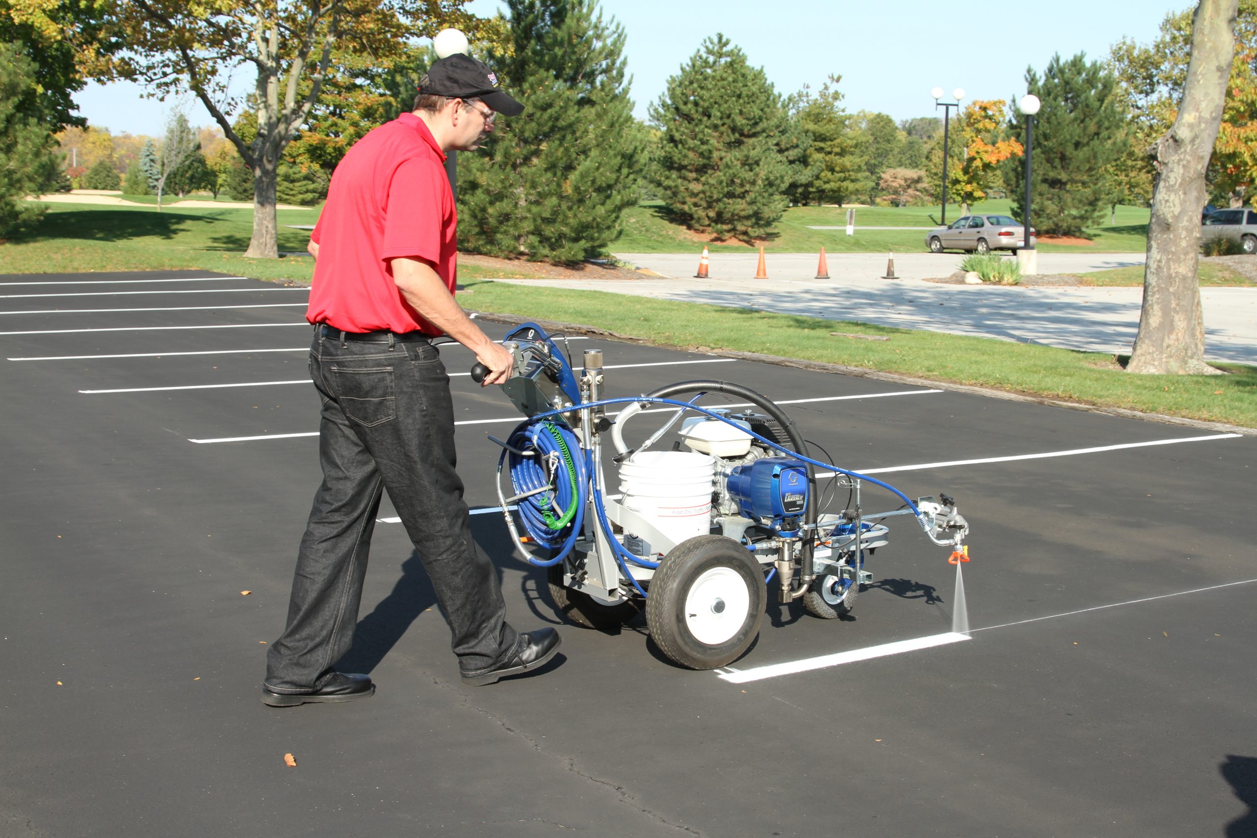 SealMaster traffic paint being applied by sealcoating contractor.