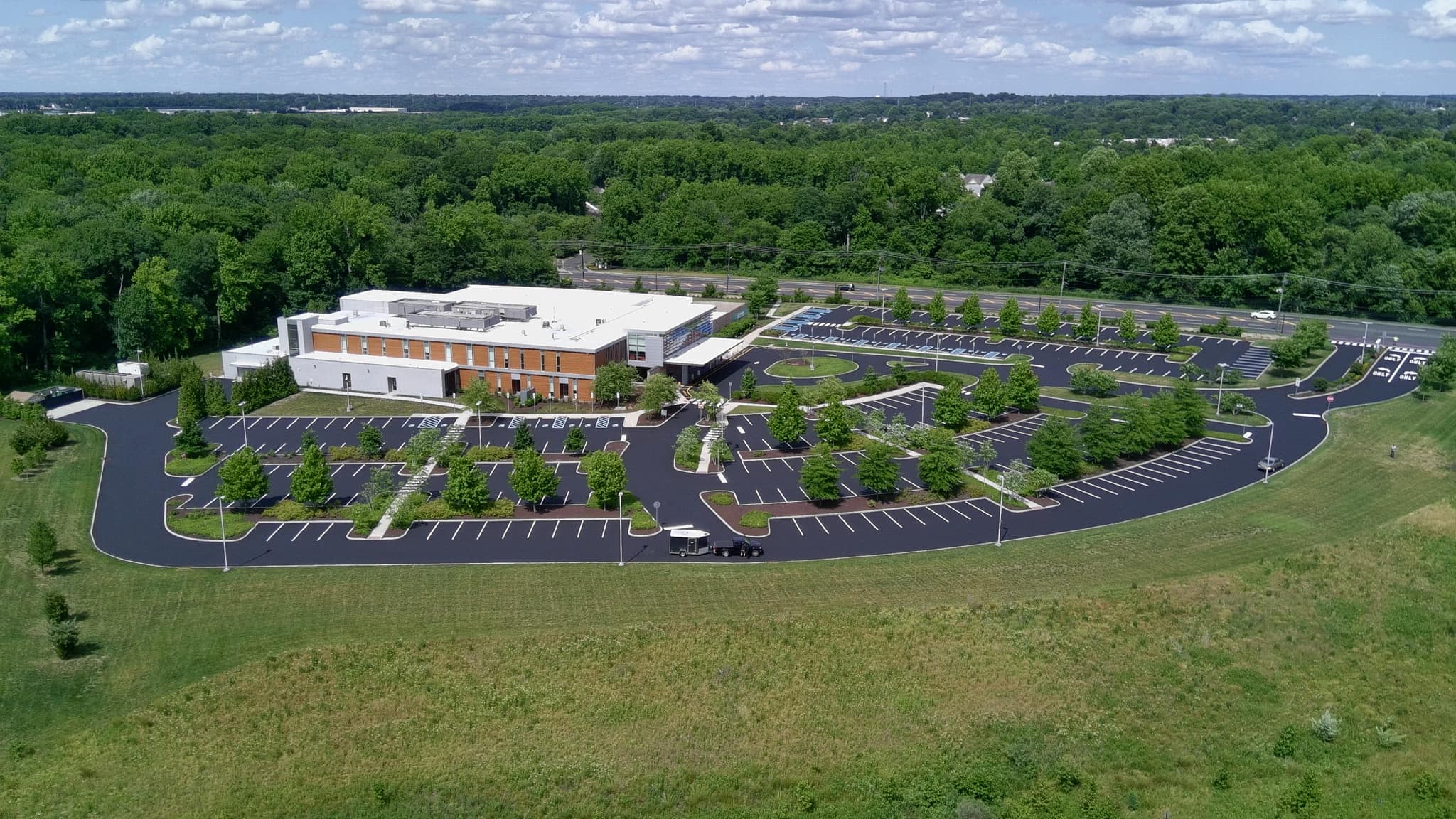 Freshly sealcoated parking lot in Delaware by Local Sealcoating / SealMaster.