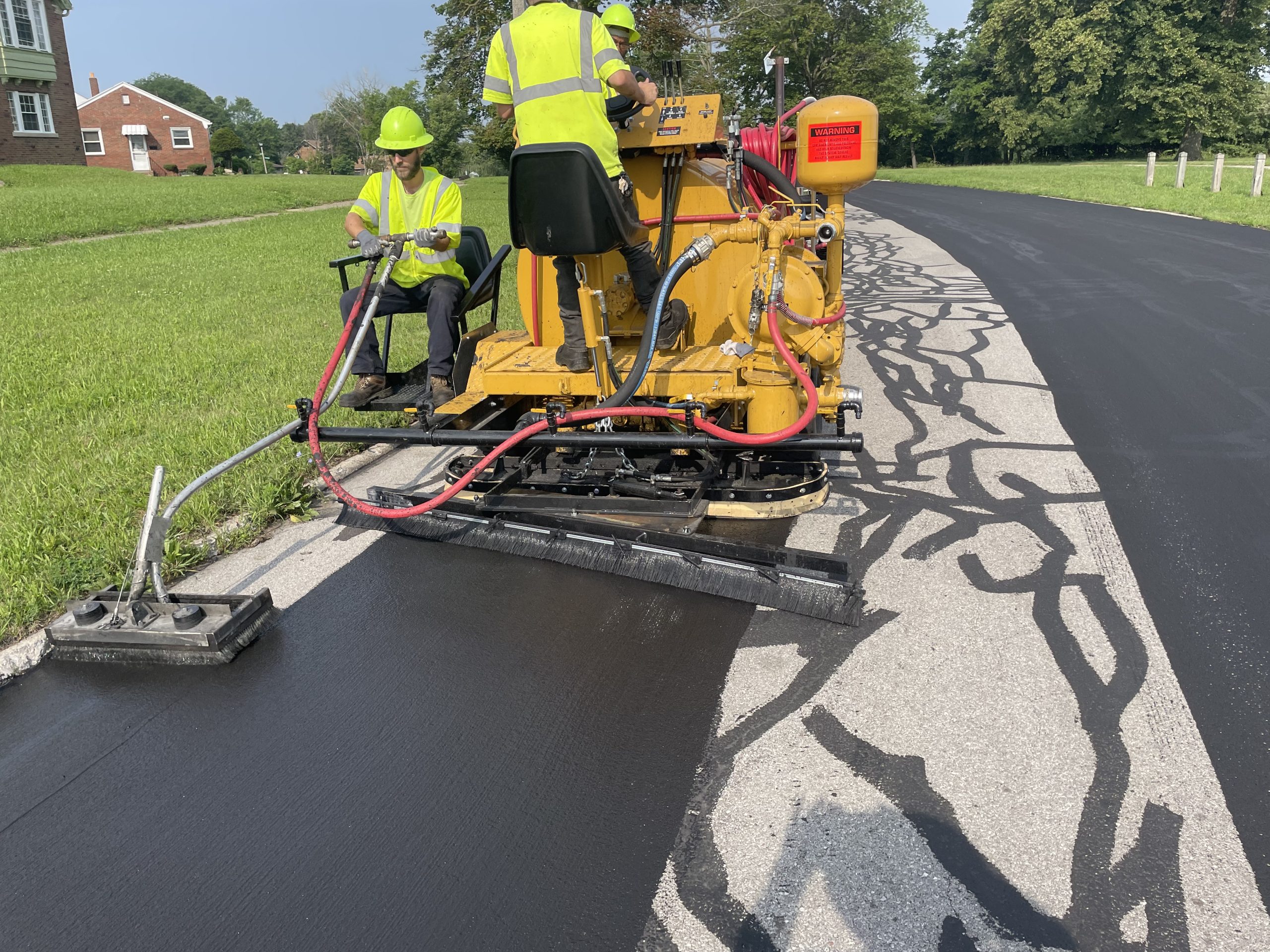 SealMaster Liquid Road being applied by sealcoating contractors.