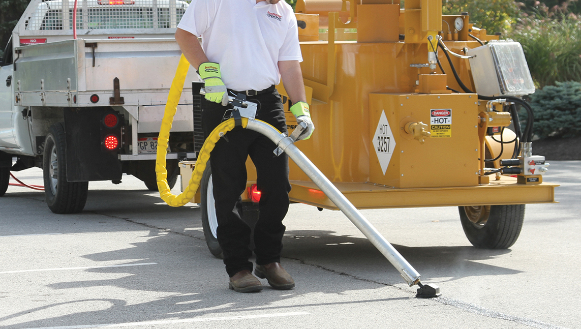 How to repair cracks in asphalt pavement. Crack filling and sealing application how-to and information - Crack cleaning with a crackpro turbo