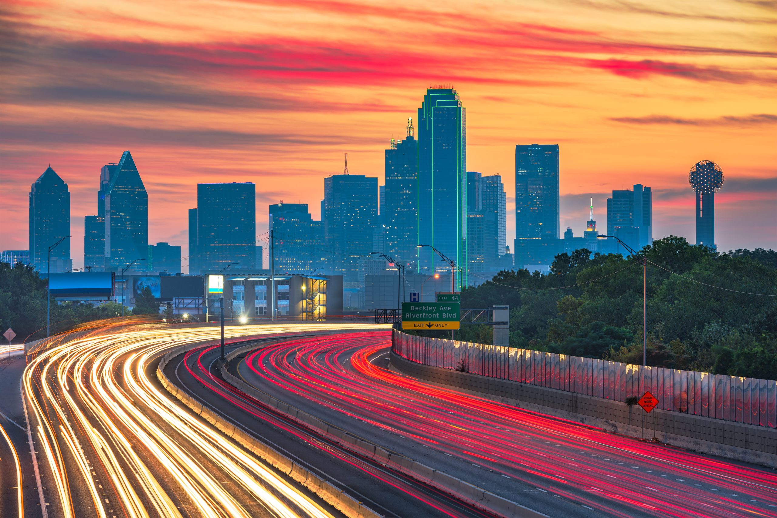 Dallas, Texas, USA downtown skyline and highway at dawn.