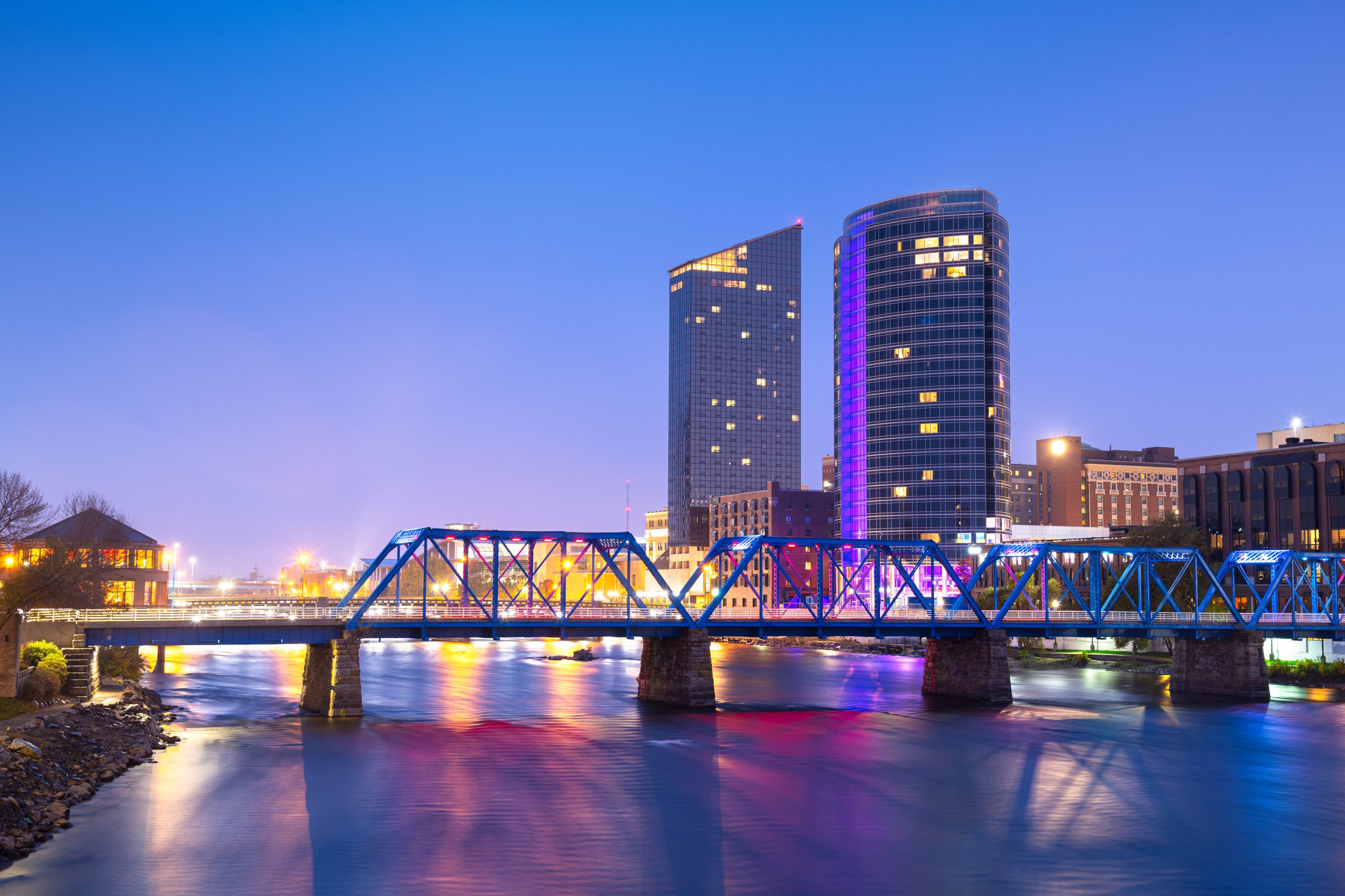 Grand Rapids, Michigan, USA downtown skyline on the Grand River at dusk.