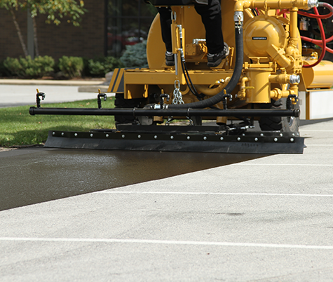 SealMaster equipment sealcoating a parking lot in Houston, TX.