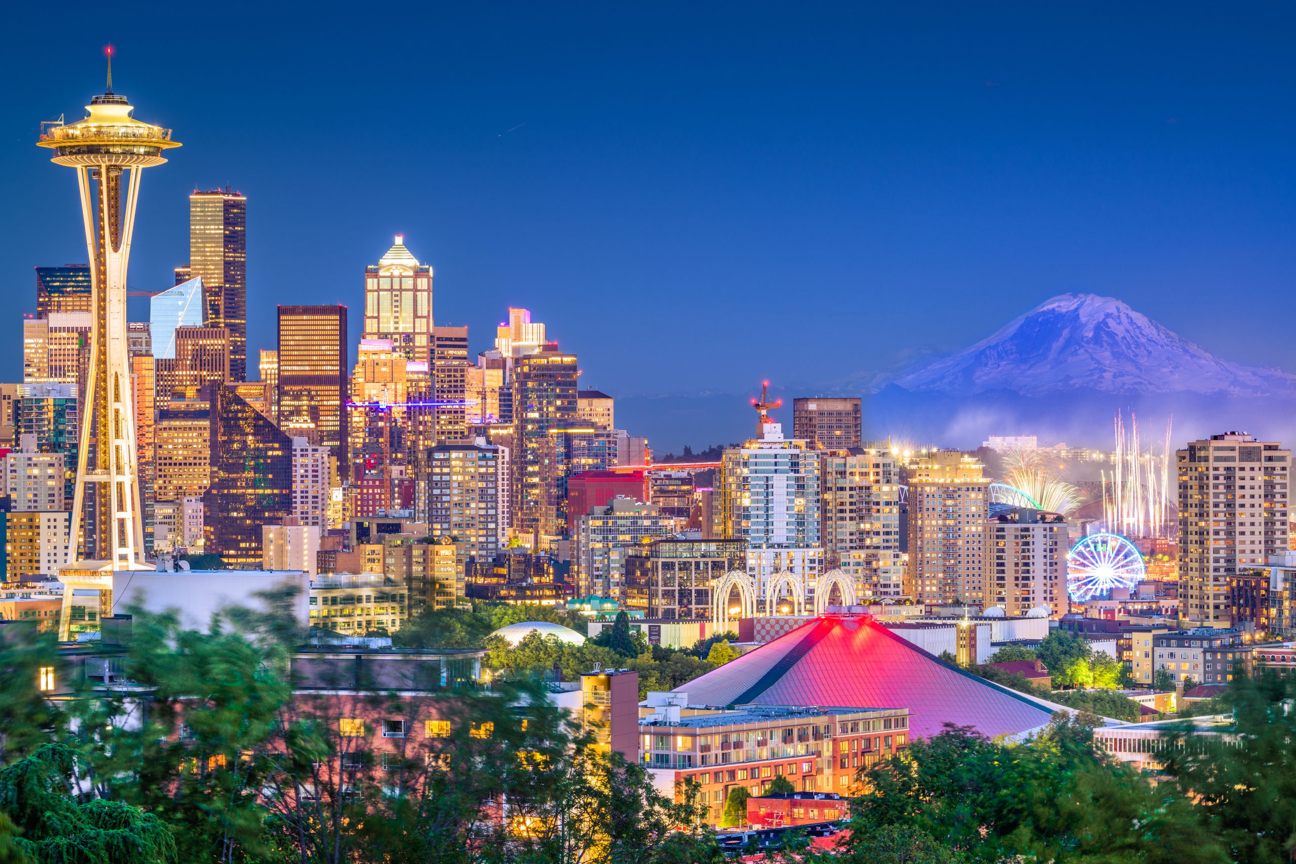 Seattle, Washington, USA downtown skyline at night with Mt. Rainier.